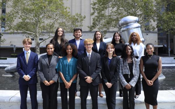 Pre-Law students pose in front of a gavel statue