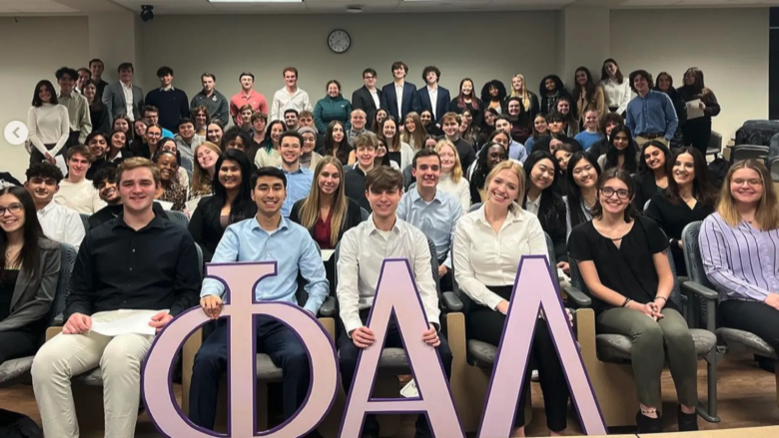 Students in auditorium style seating with Phi Alpha Delta letters in front