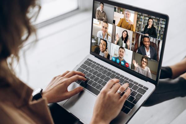Stock image of laptop and webinar audience