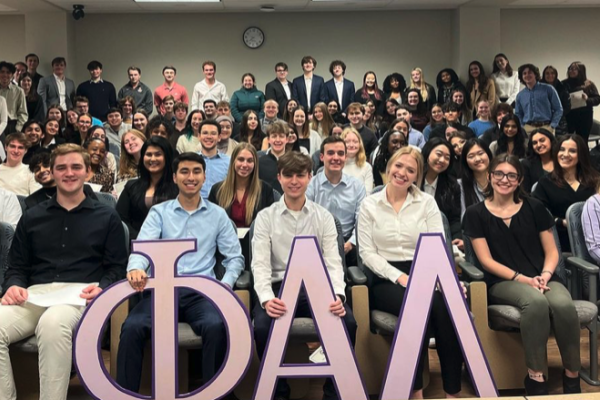 Students in auditorium style seating with Phi Alpha Delta letters in front
