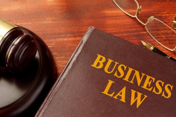 Gavel, glasses, and book titled "Business Law"