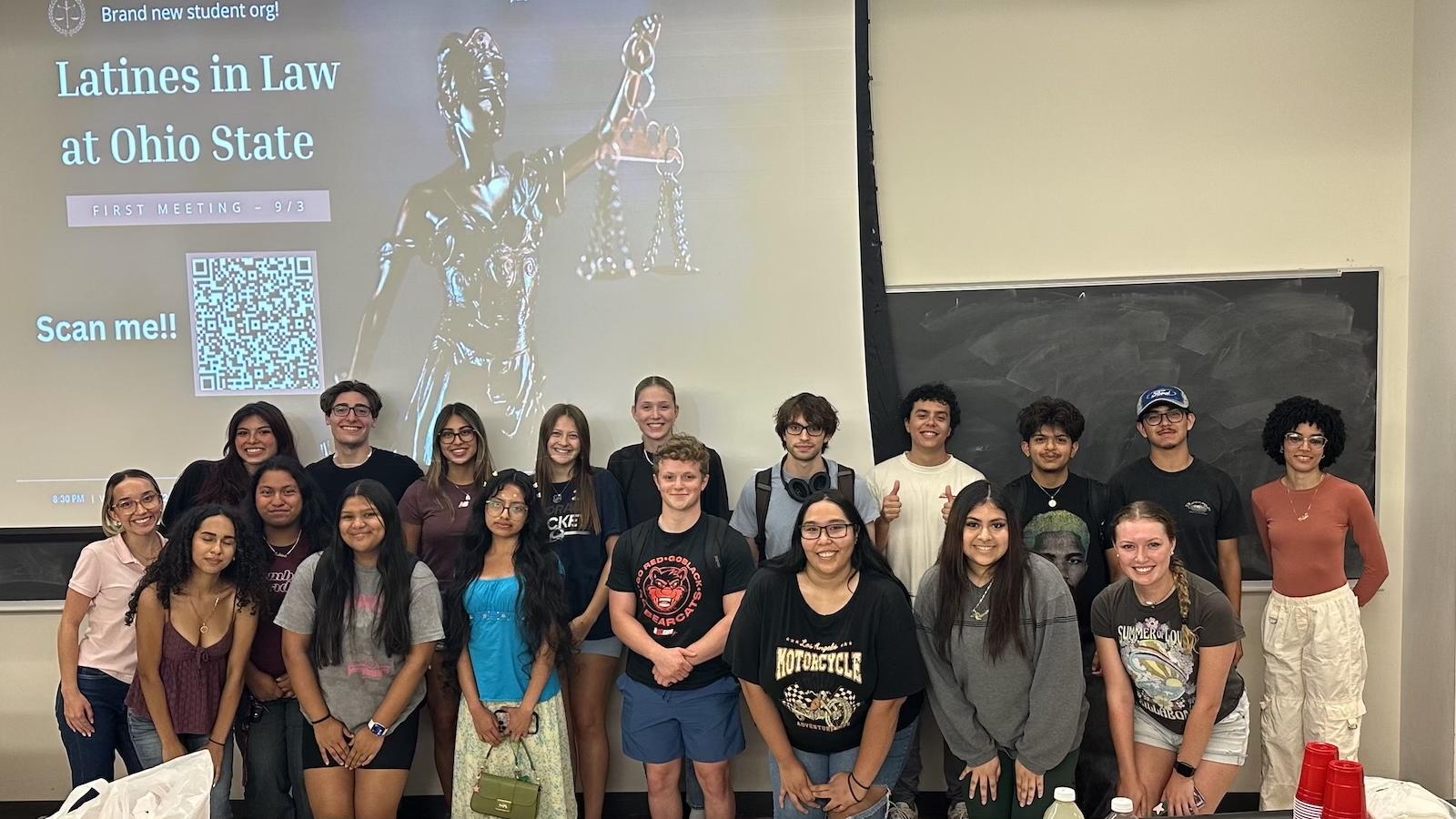 Two rows of students in front of projector screen